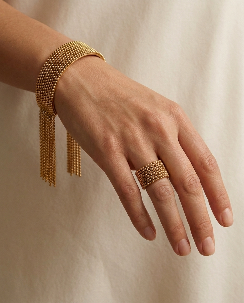 Cascade Fringe Cuff, Gold finish, worn on a single wrist with the matching Beaded Tassel Ring