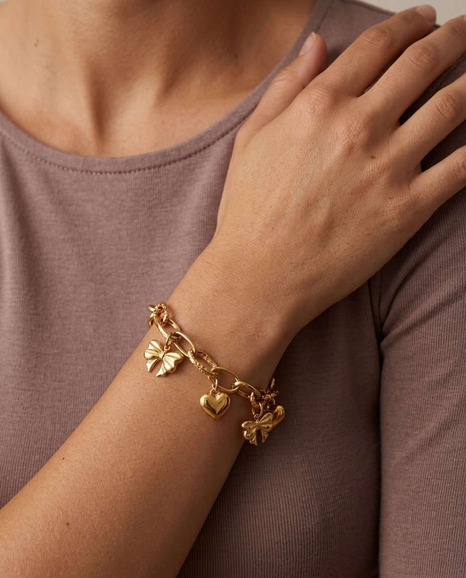 Heart and Bow Charm Bracelet, Gold finish, worn on wrist