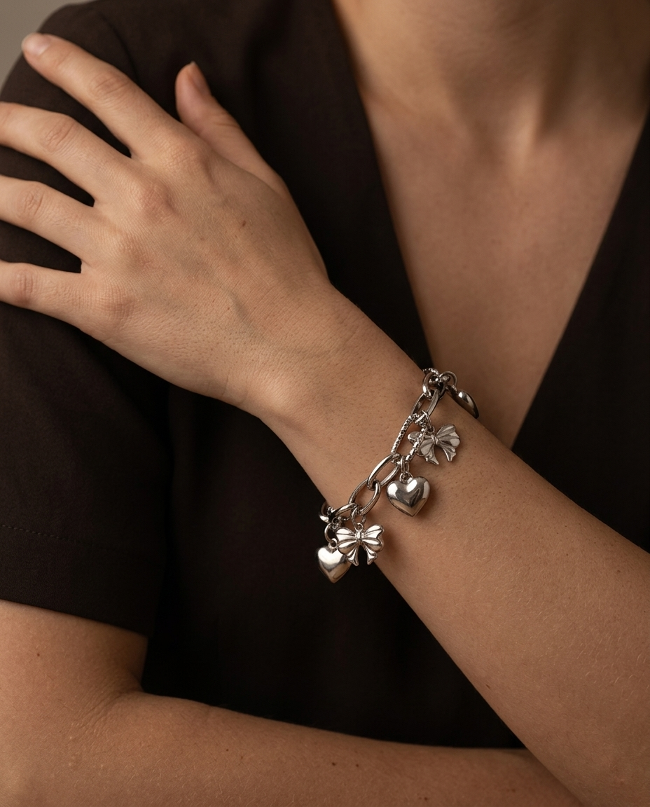 Heart and Bow Charm Bracelet, Silver finish, worn on wrist