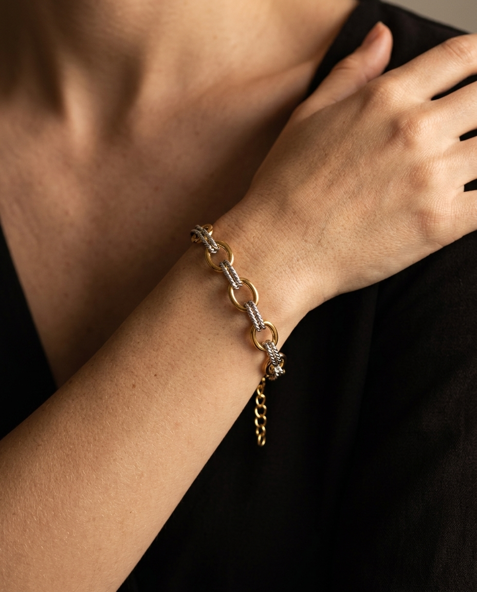 Two-Tone Oval Link Bracelet, worn on wrist in a self-embrace pose