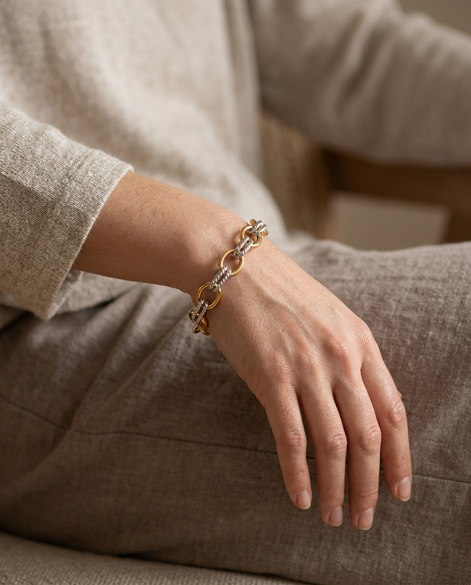 Two-Tone Oval Link Bracelet, worn on wrist, hand resting at the side