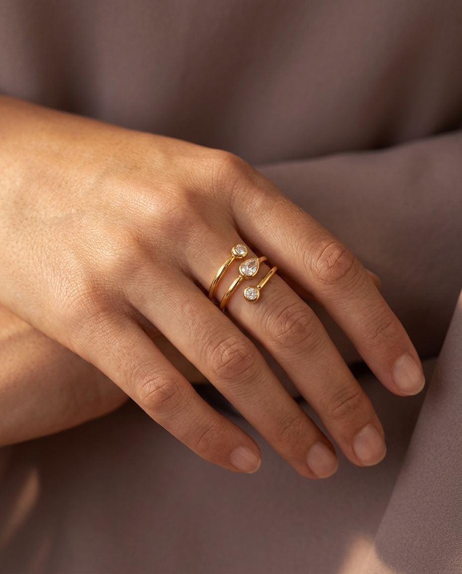 Spiral Teardrop Ring, Gold finish, worn on a relaxed hand