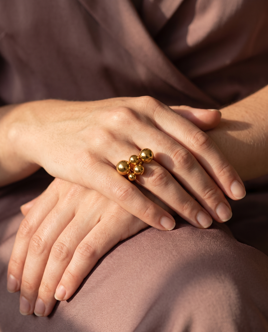 Sphere Cluster Ring, Gold finish, worn on a relaxed hand